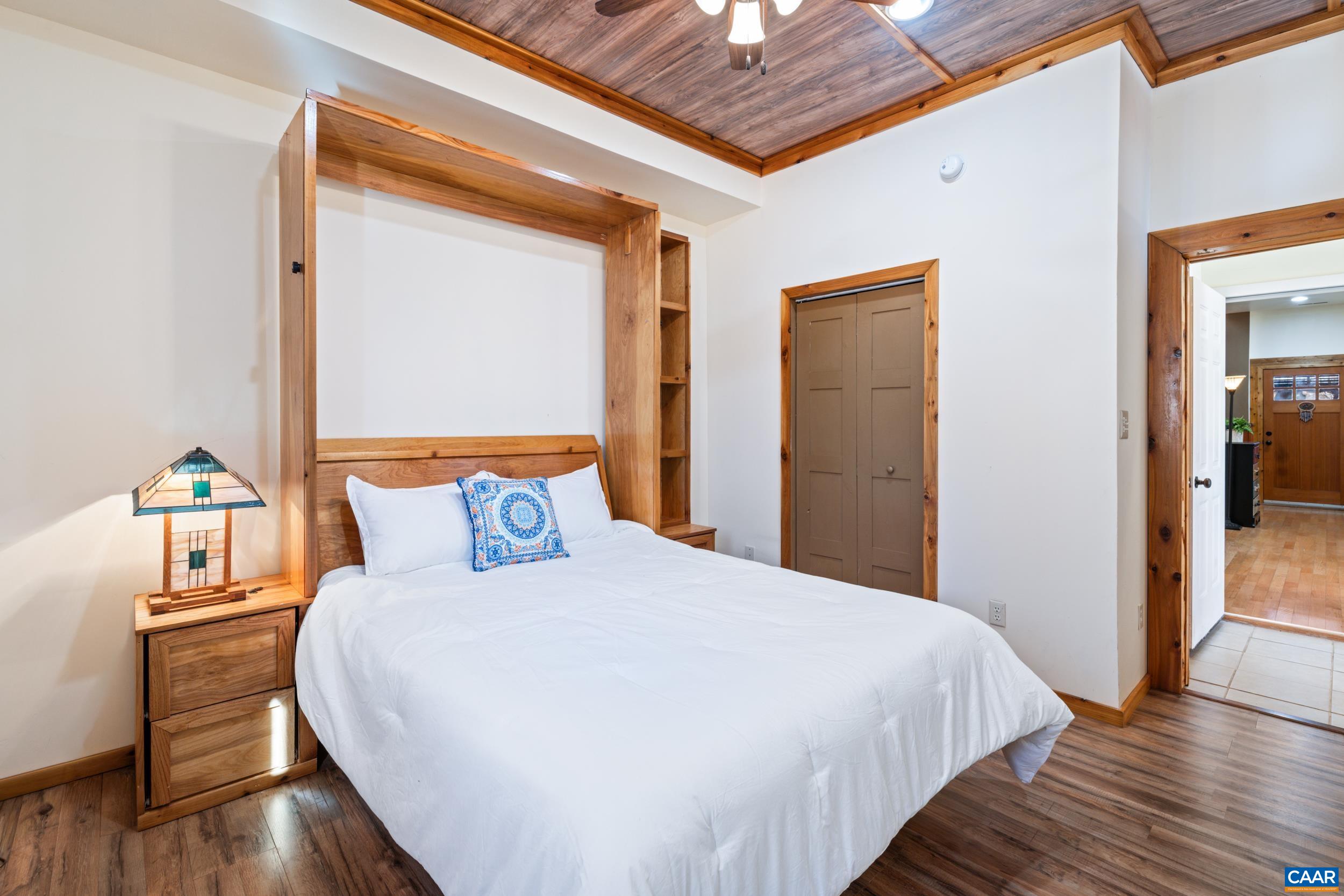 6696 Highlander Way Crozet, VA 22932 - Photo 48 of 71 a bedroom with a bed and wooden floor