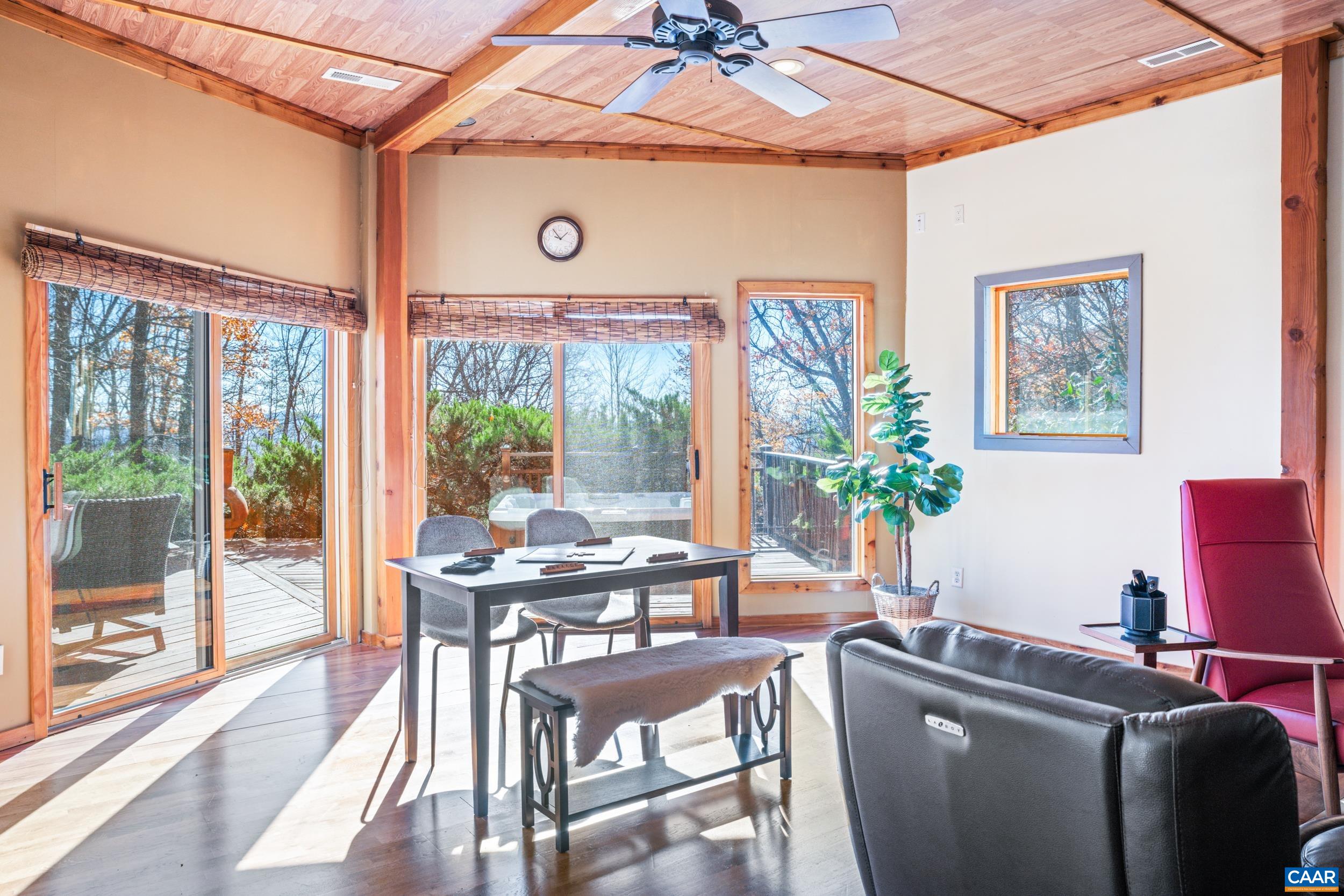 6696 Highlander Way Crozet, VA 22932 - Photo 51 of 71 a dining room with furniture wooden floor and a potted plant