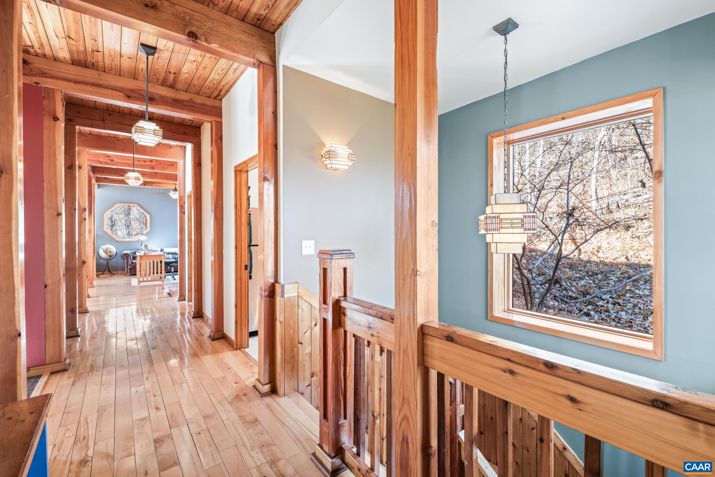 6696 Highlander Way Crozet, VA 22932 - Photo 6 of 71 a view of a hallway with wooden floor and windows