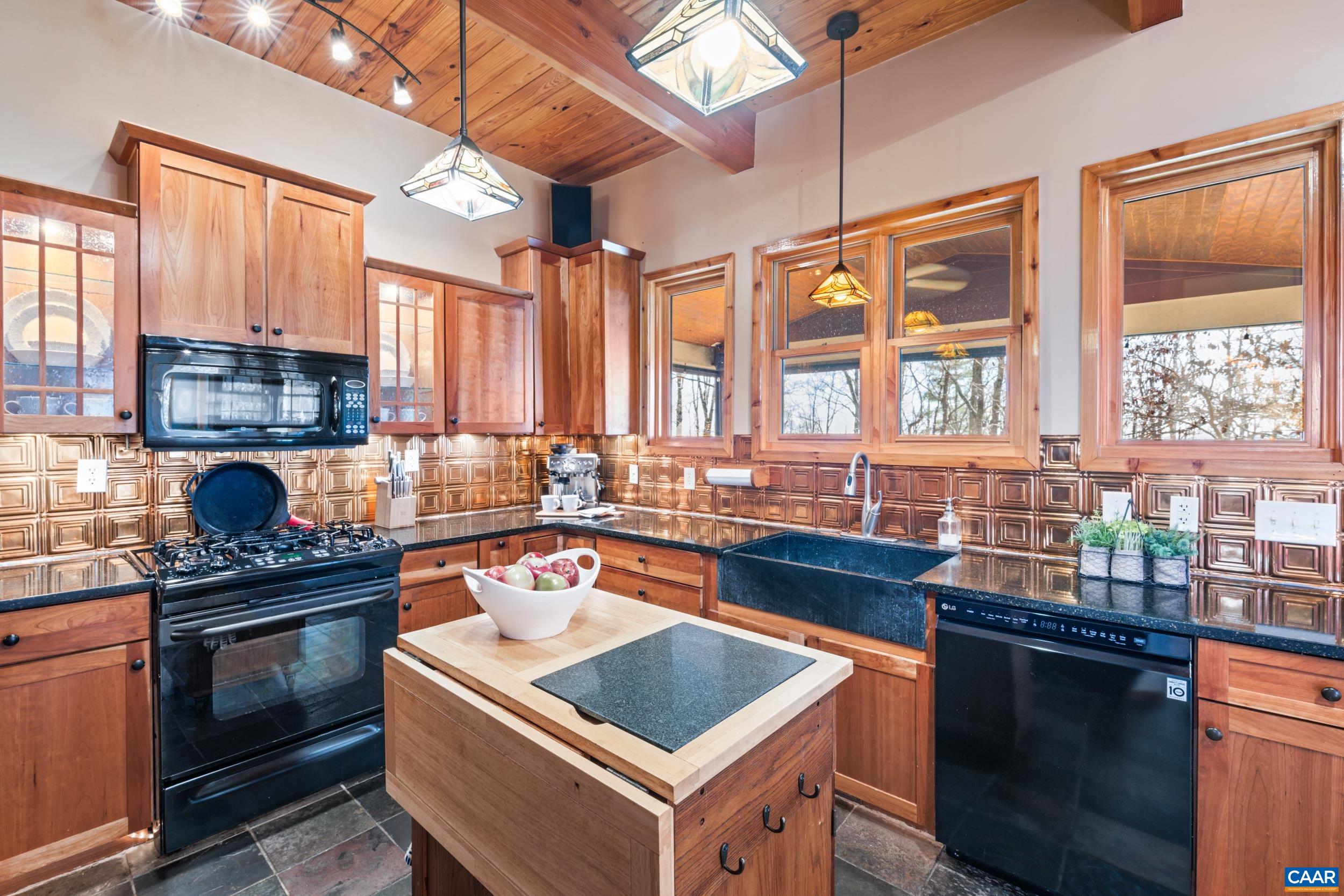 6696 Highlander Way Crozet, VA 22932 - Photo 9 of 71 a kitchen with stainless steel appliances granite countertop a stove a sink and a microwave