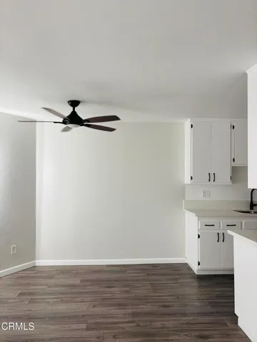 a view of a kitchen with wooden floor