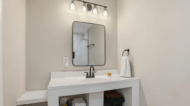a bathroom with a sink and a mirror