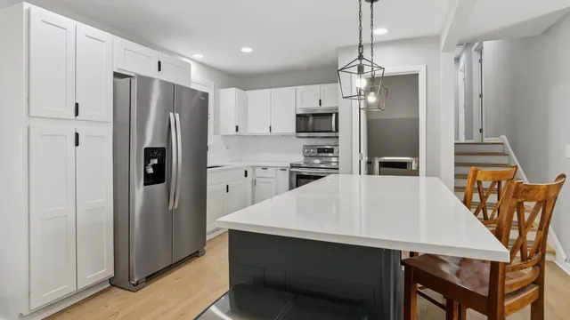 a kitchen with stainless steel appliances a refrigerator and a stove
