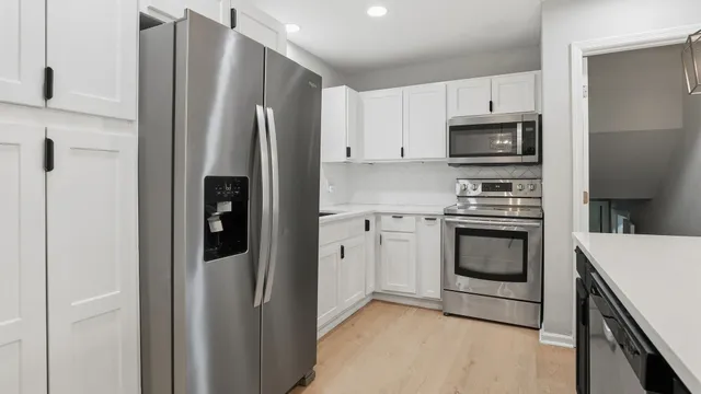 a kitchen with stainless steel appliances a refrigerator stove and microwave