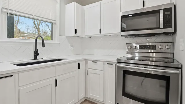 a kitchen with a stove and a microwave
