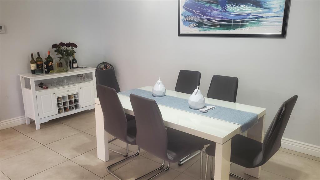 616 Southeast 8th Avenue Deerfield Beach, FL 33441 - Photo 14 of 38 a view of a dining room with furniture and wooden floor