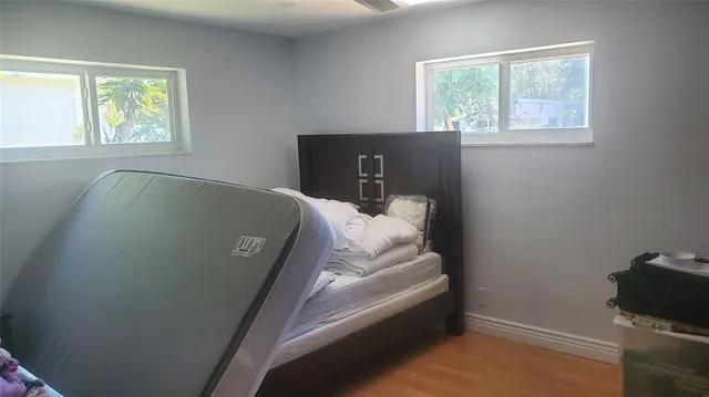 a bed sitting in a bedroom next to a window