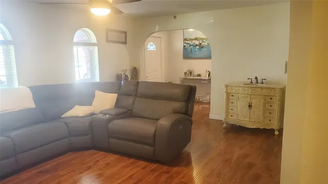 a living room with furniture and painting on the wall
