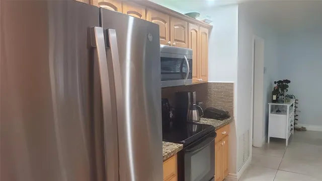 a kitchen with a refrigerator and cabinets