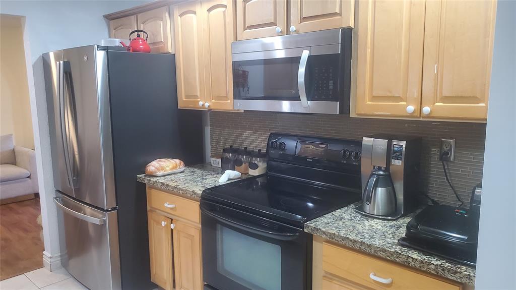 616 Southeast 8th Avenue Deerfield Beach, FL 33441 - Photo 10 of 38 a kitchen with stainless steel appliances granite countertop a refrigerator and a stove