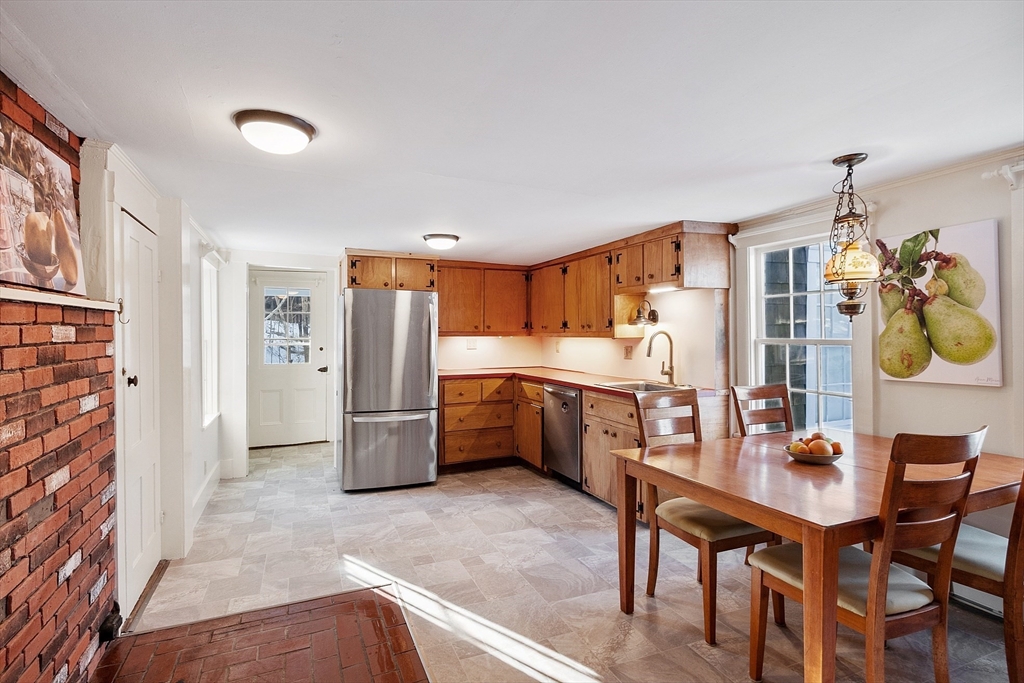 25 Bulkeley Road, Unit CENTER Littleton, MA 01460 - Photo 11 of 40 a kitchen with stainless steel appliances a refrigerator and a stove top oven