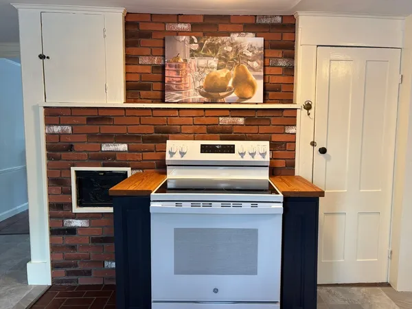 a stove top oven sitting inside of a kitchen