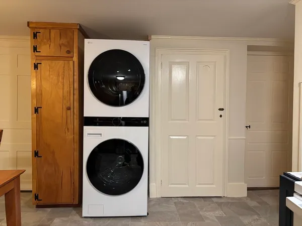 a view of a hallway with wooden floor and closet