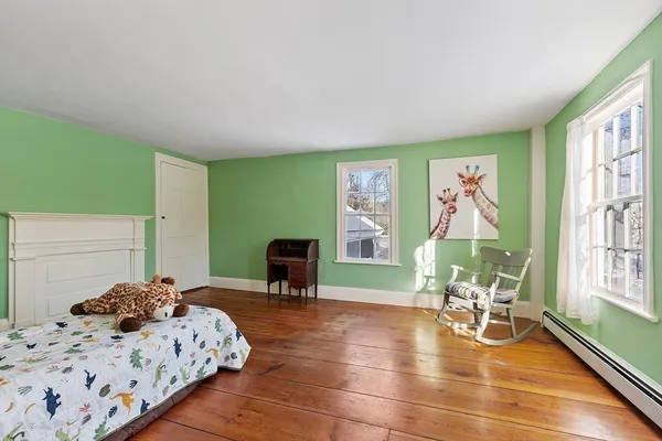 a bedroom with furniture and a large window