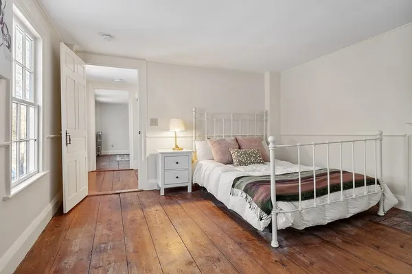 a bedroom with furniture and a window