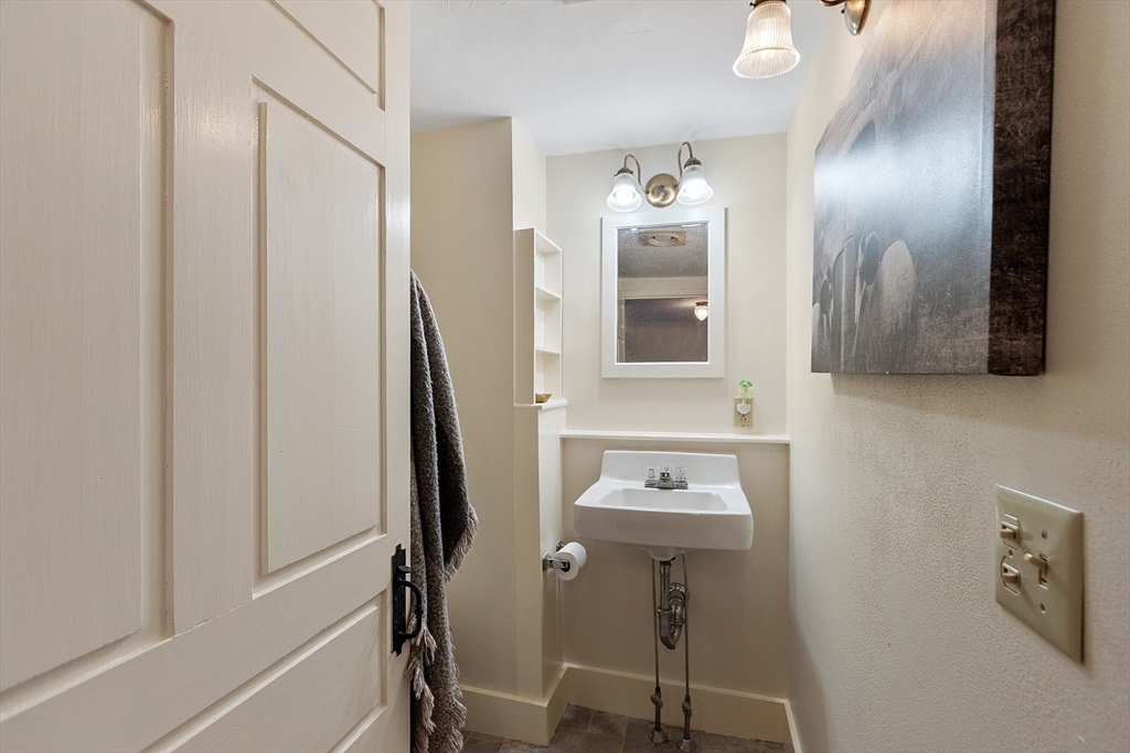 25 Bulkeley Road, Unit CENTER Littleton, MA 01460 - Photo 35 of 40 a bathroom with a sink a mirror and shower