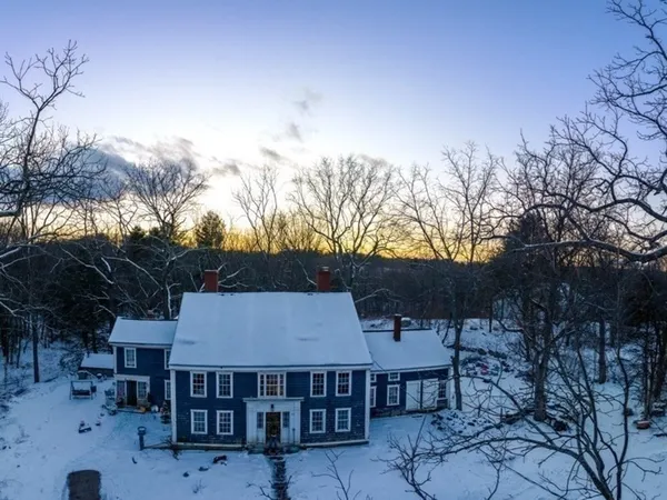 a aerial view of house with yard and mountain in the background