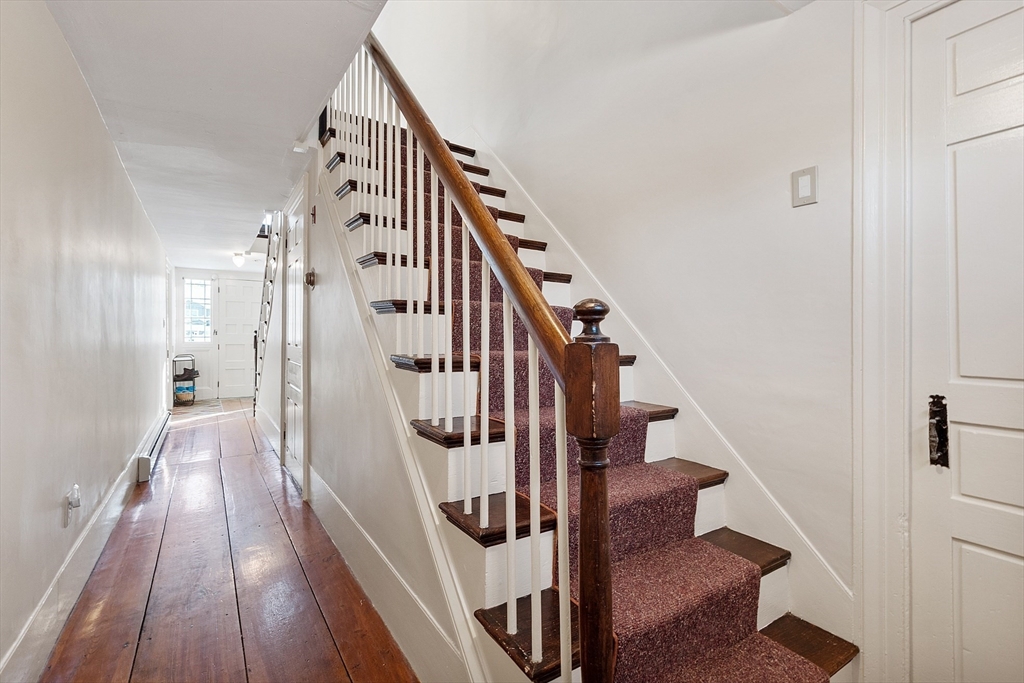 25 Bulkeley Road, Unit CENTER Littleton, MA 01460 - Photo 5 of 40 a view of staircase with wooden floor and white walls