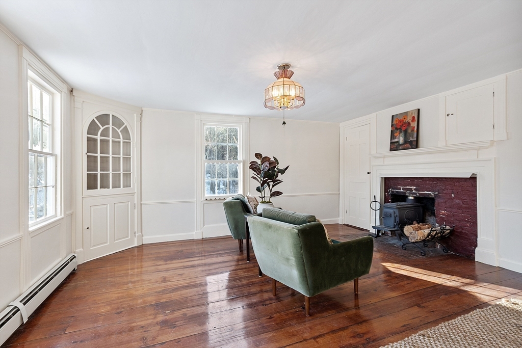 25 Bulkeley Road, Unit CENTER Littleton, MA 01460 - Photo 7 of 40 a living room with furniture flowerpot and wooden floor