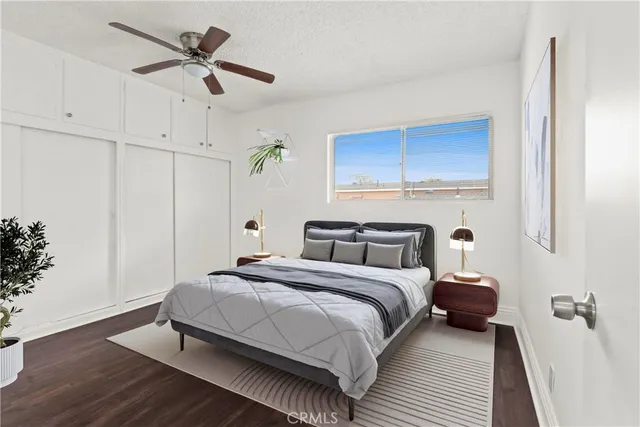 a bedroom with a bed and a ceiling fan