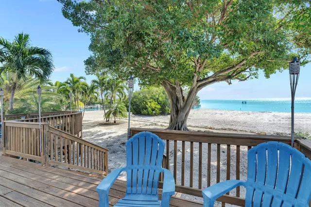 a view of balcony with wooden floor and fence