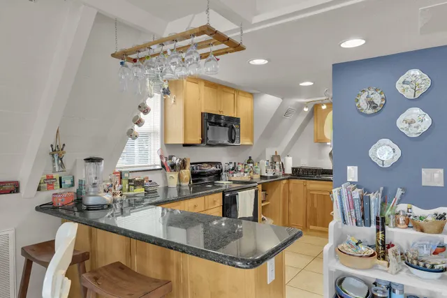 a kitchen with stainless steel appliances granite countertop a sink a stove and a microwave