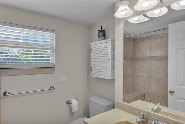 a bathroom with a toilet a sink and a shower