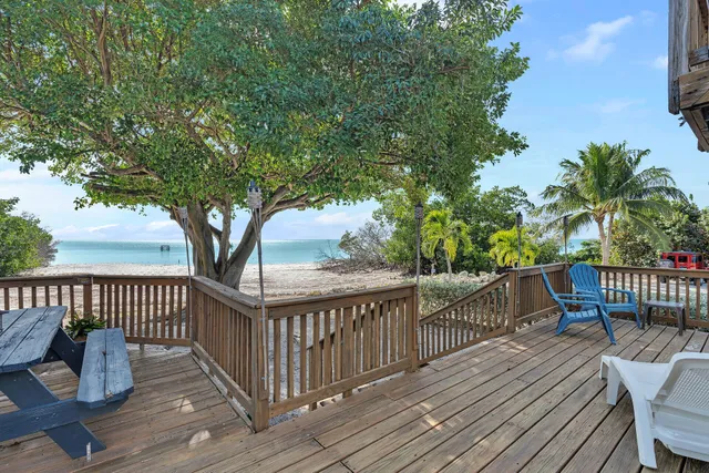 a view of a deck with furniture and wooden floor