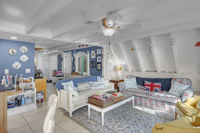 a living room with furniture and a dining table