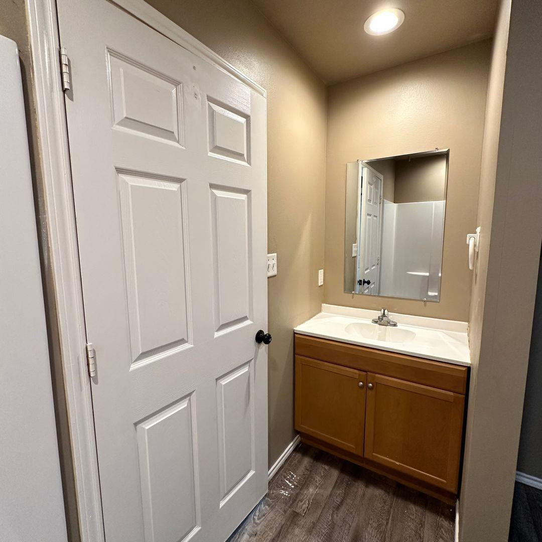 113 36th Street Lubbock, TX 79404 - Photo 8 of 12 a bathroom with a sink and mirror
