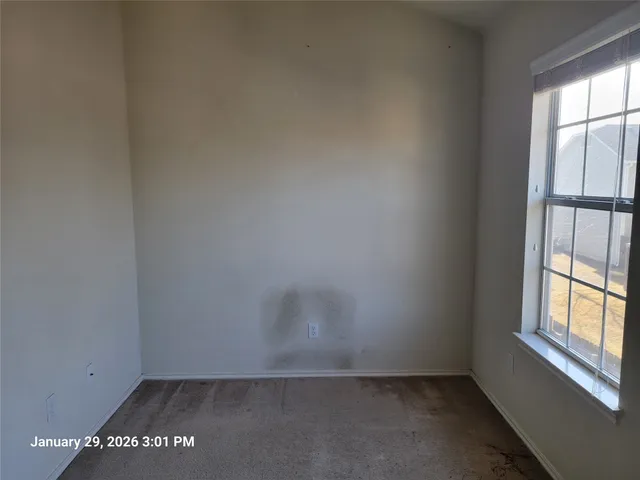 an empty room with a ceiling fan