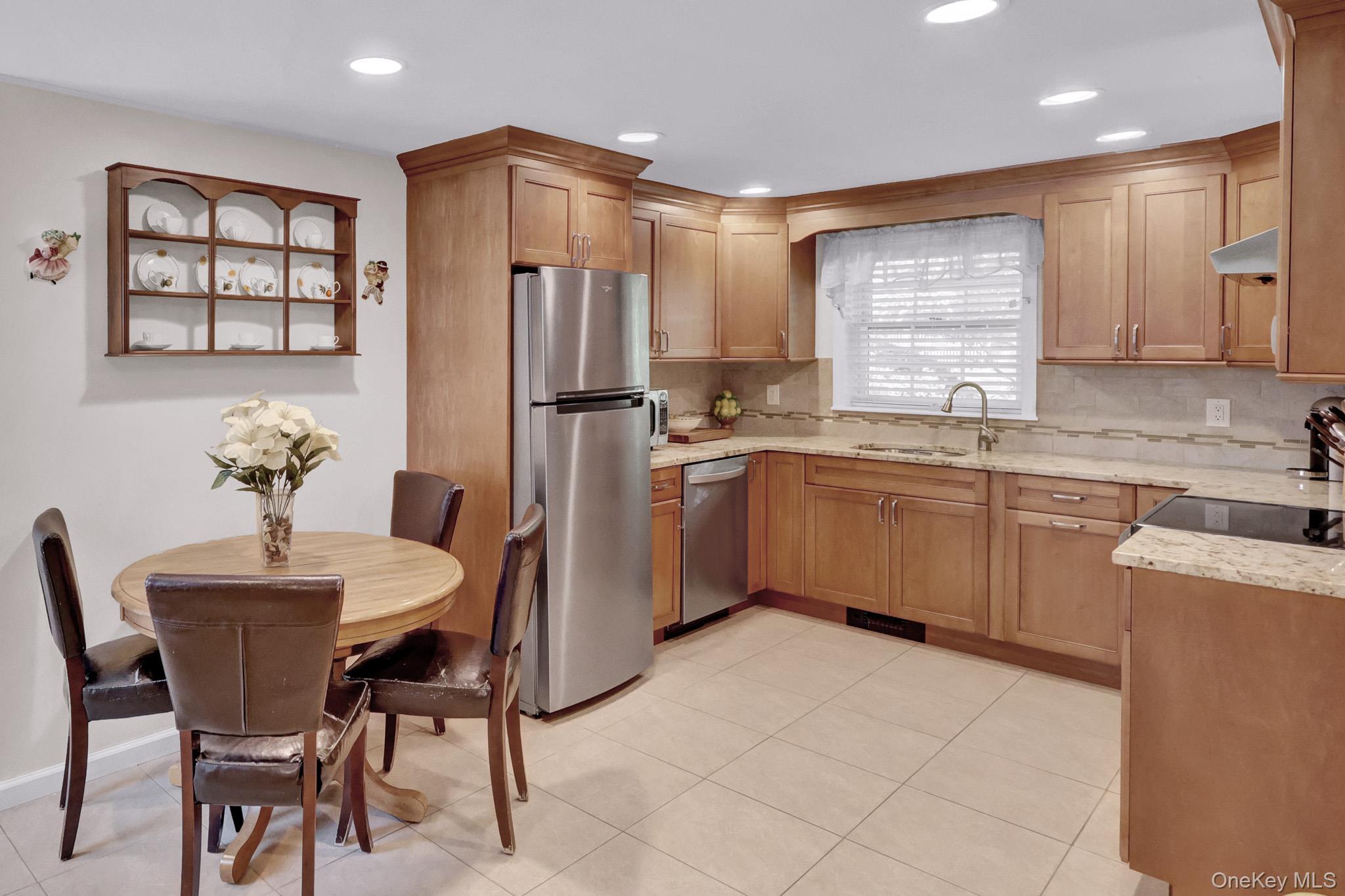 121 Old Field Road Huntington, NY 11743 - Photo 25 of 38 The apartment’s Granite EIK with wood cabinets and stainless steel appliances.