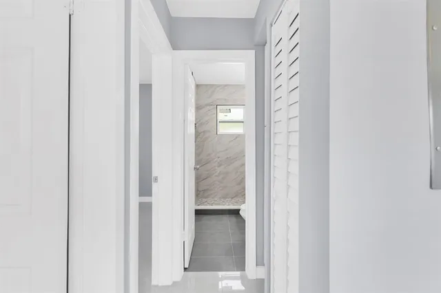 a view of a bathroom from a corridor