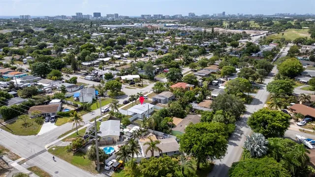 an aerial view of residential houses with city view
