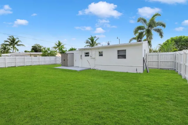 a view of house with backyard and garden