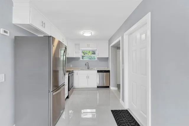a kitchen with a refrigerator a sink and dishwasher