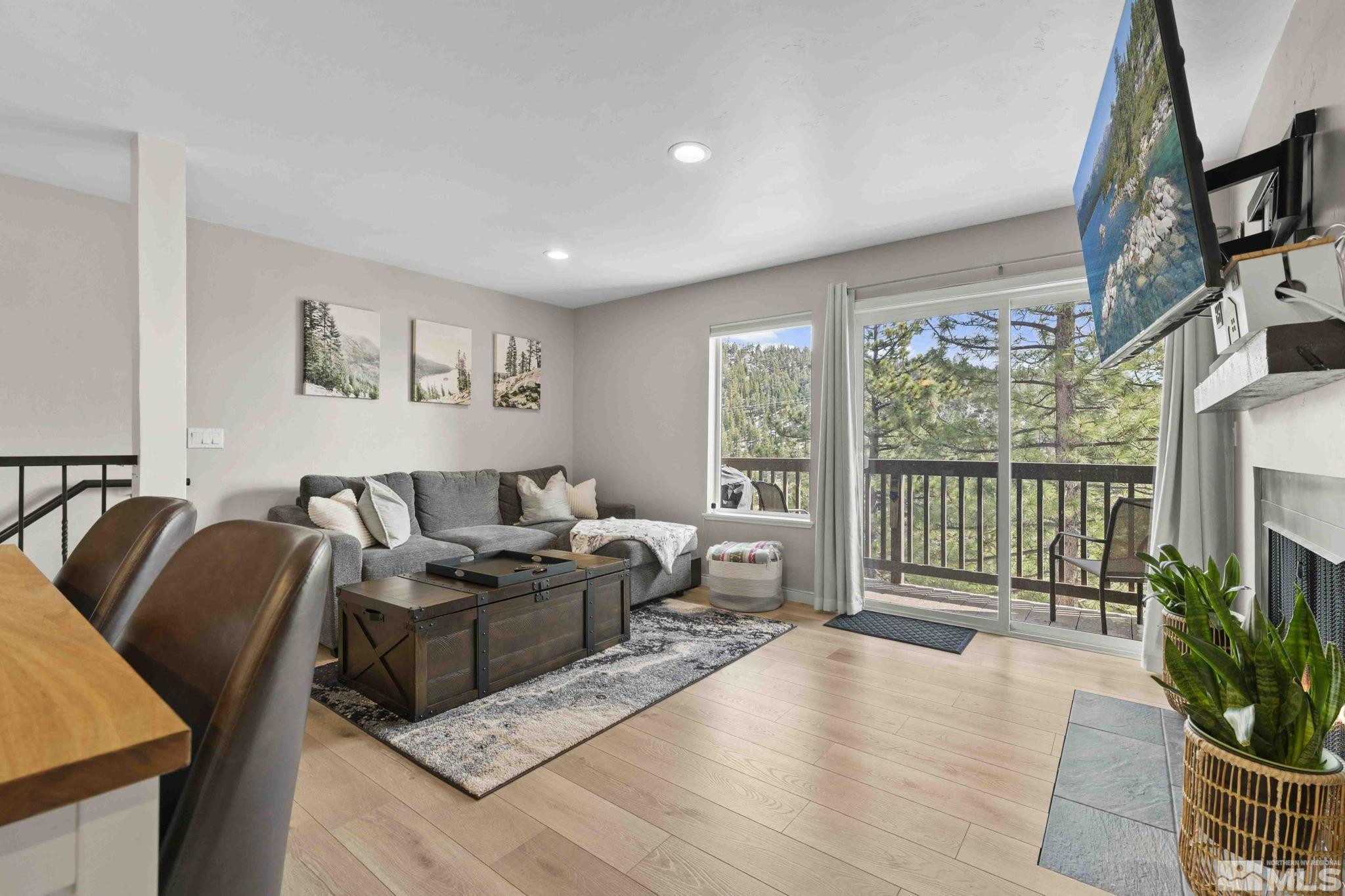 115 Tramway Drive, Unit 2 Stateline, NV 89449 - Photo 5 of 22 a living room with furniture floor to ceiling window and a flat screen tv