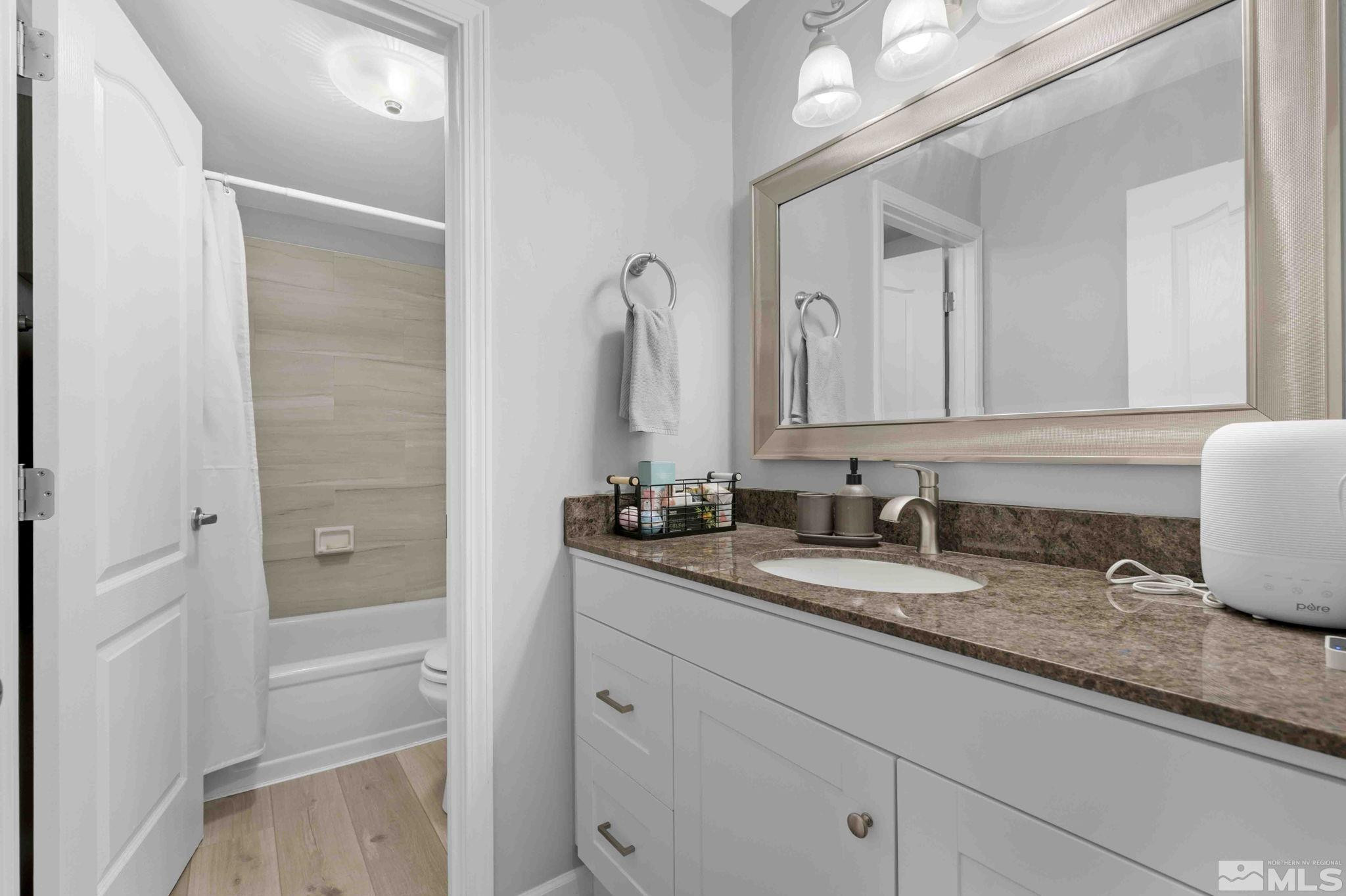115 Tramway Drive, Unit 2 Stateline, NV 89449 - Photo 8 of 22 a bathroom with a granite countertop sink and a mirror
