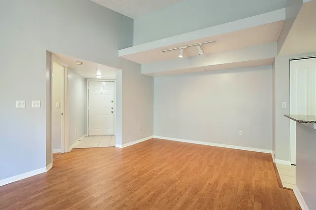 a view of empty room with wooden floor