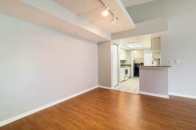 a view of a kitchen with a sink and a refrigerator
