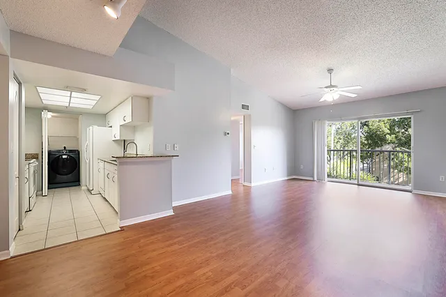 a view of a kitchen with wooden floor and a kitchen