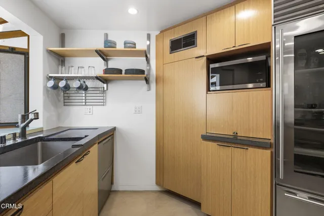 a living room with furniture a flat screen tv and a table