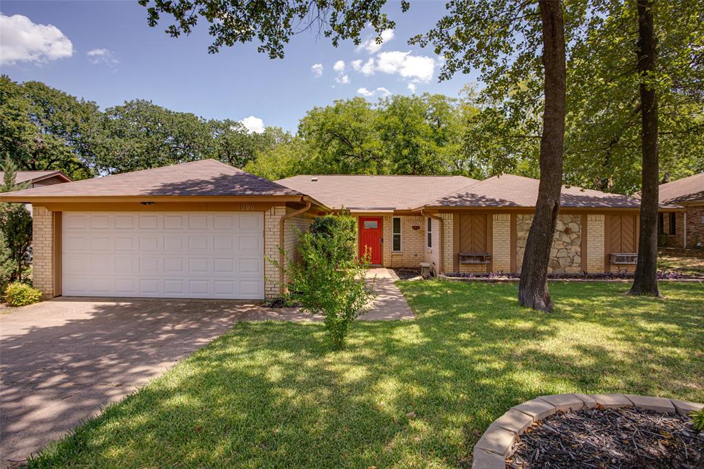 1200 Timber Ridge Drive Euless, TX 76039 - Photo 1 of 1 a front view of a house with a yard and garage