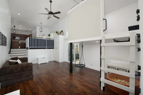 a living room with furniture and wooden floor