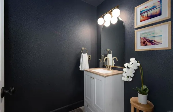 a bathroom with a sink mirror and vanity