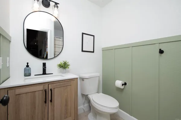 a bathroom with a toilet sink and mirror