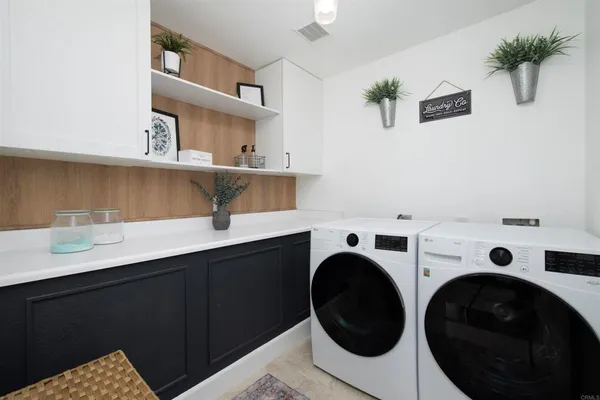 a view of cabinets and washer dryer