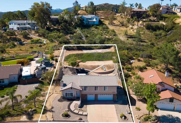 an aerial view of a house with a swimming pool