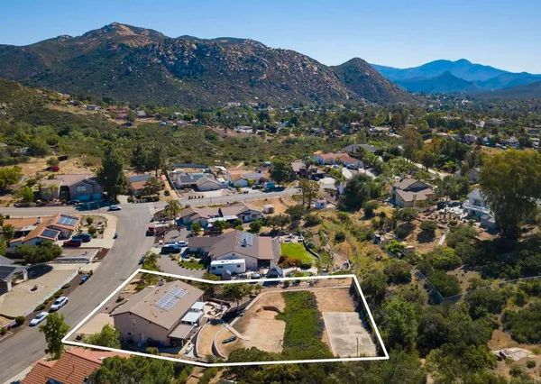 an aerial view of residential houses and outdoor space
