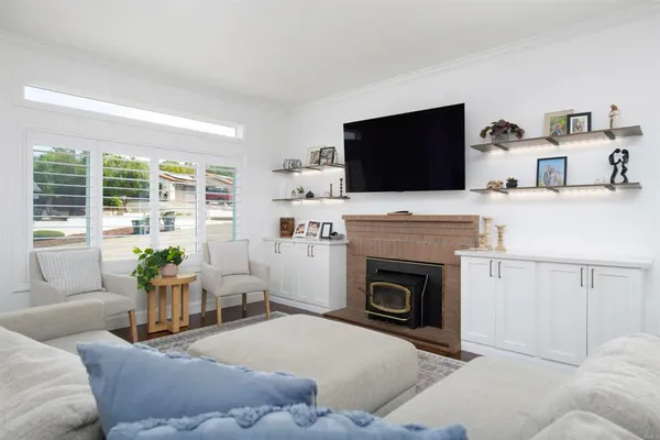 a living room with furniture a flat screen tv and a fireplace